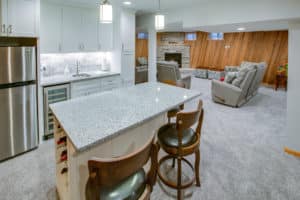 Basement remodel with kitchen and built-in fireplace.