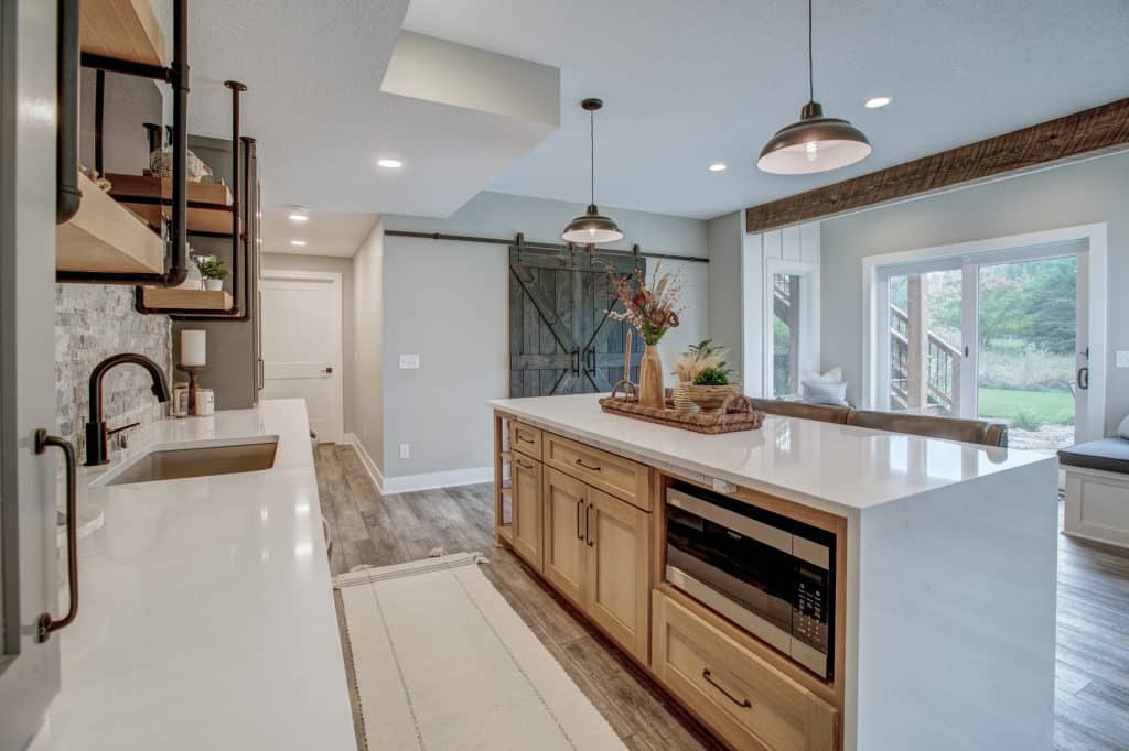 Kitchen remodel with white quartz countertops, large island, and open shelving.