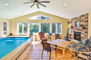 Home remodeled with sunroom with an indoor pool