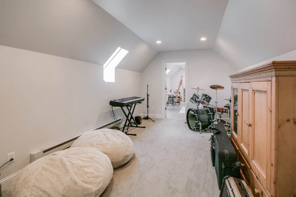 Finished upper-level bonus room with a skylight above a garage in Greenwood MN by Stonehearth Remodeling